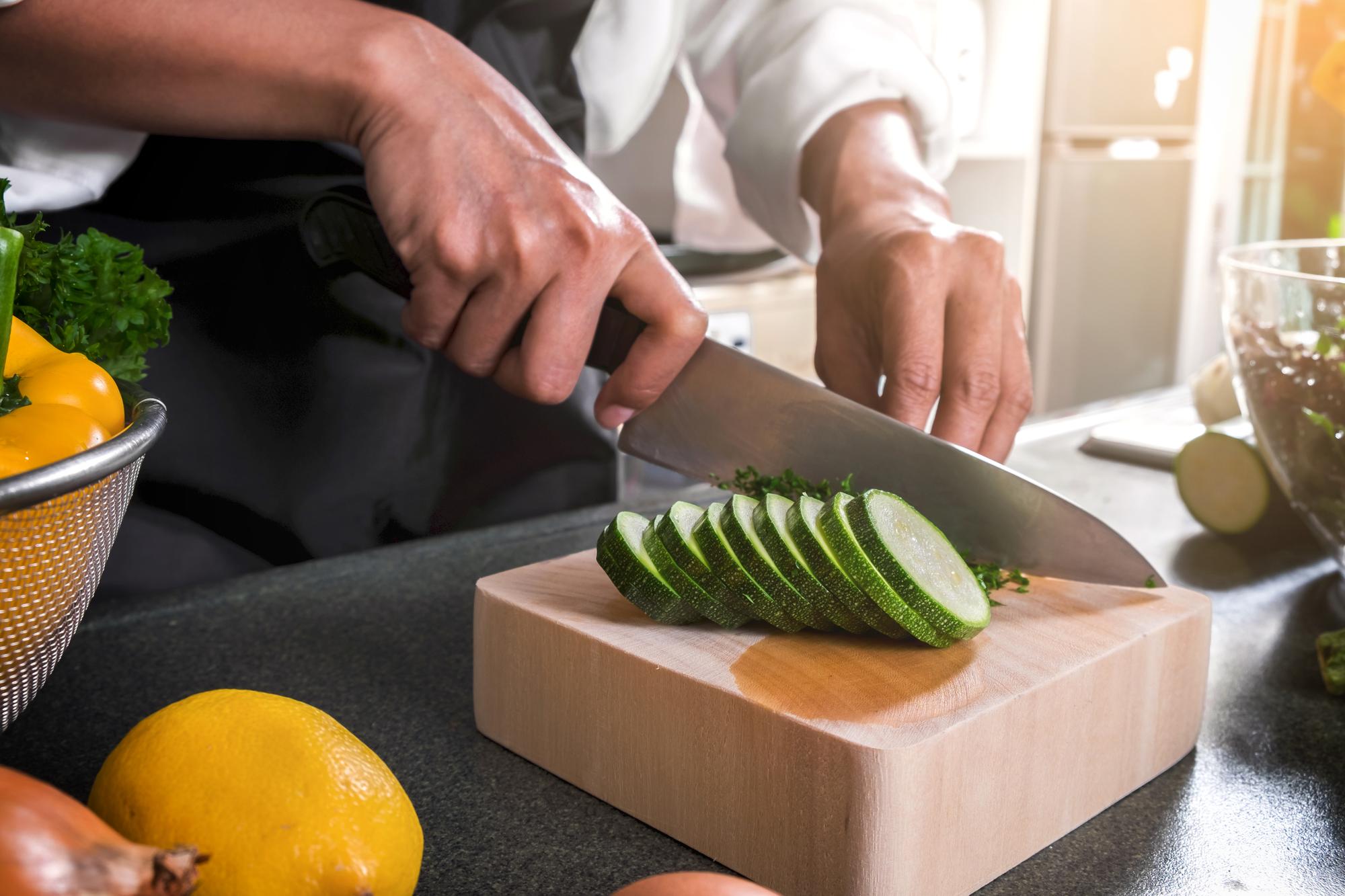 Instructor slicing seasonal vegetables in the workshop