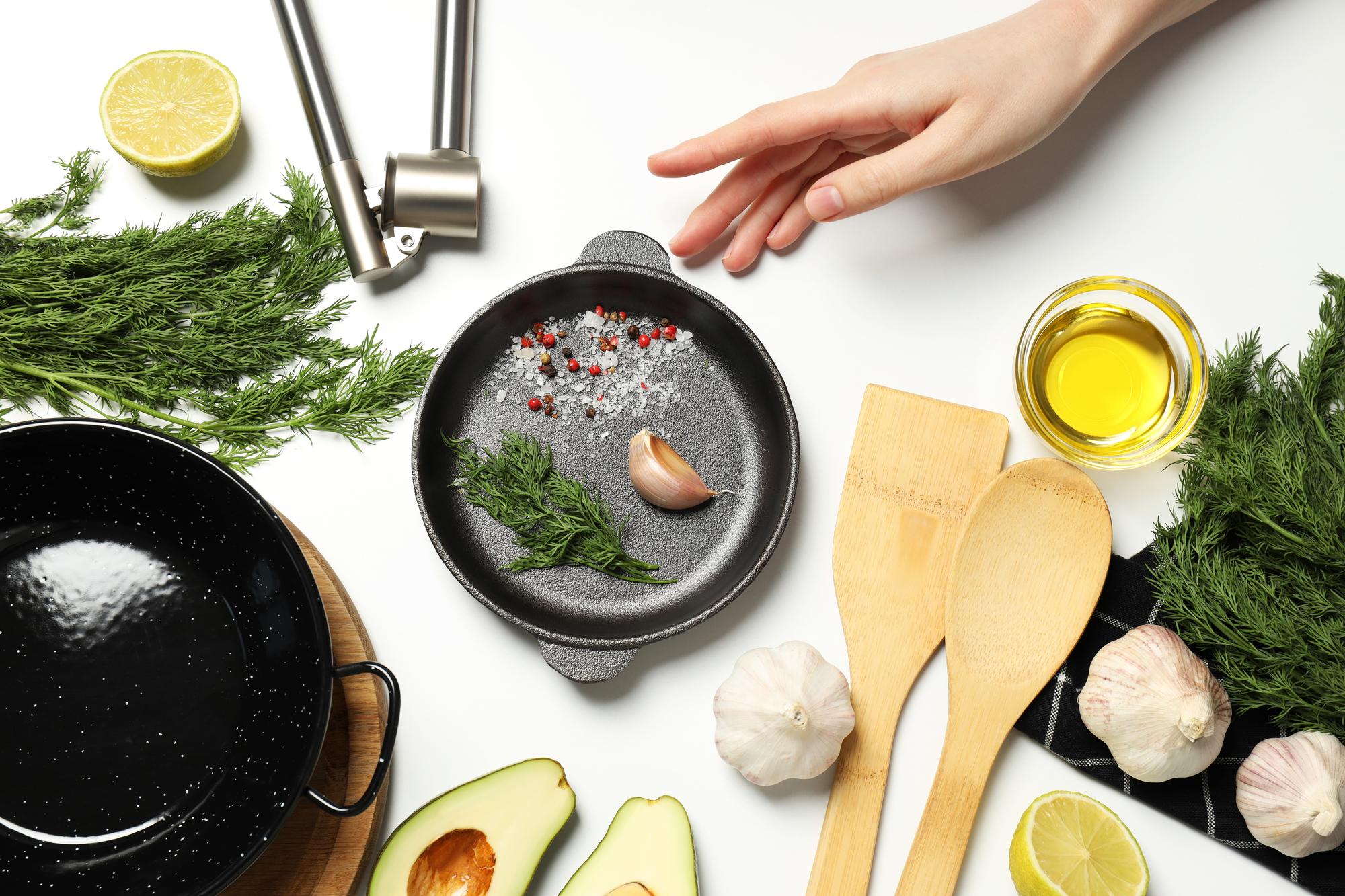 Hands seasoning a pan
