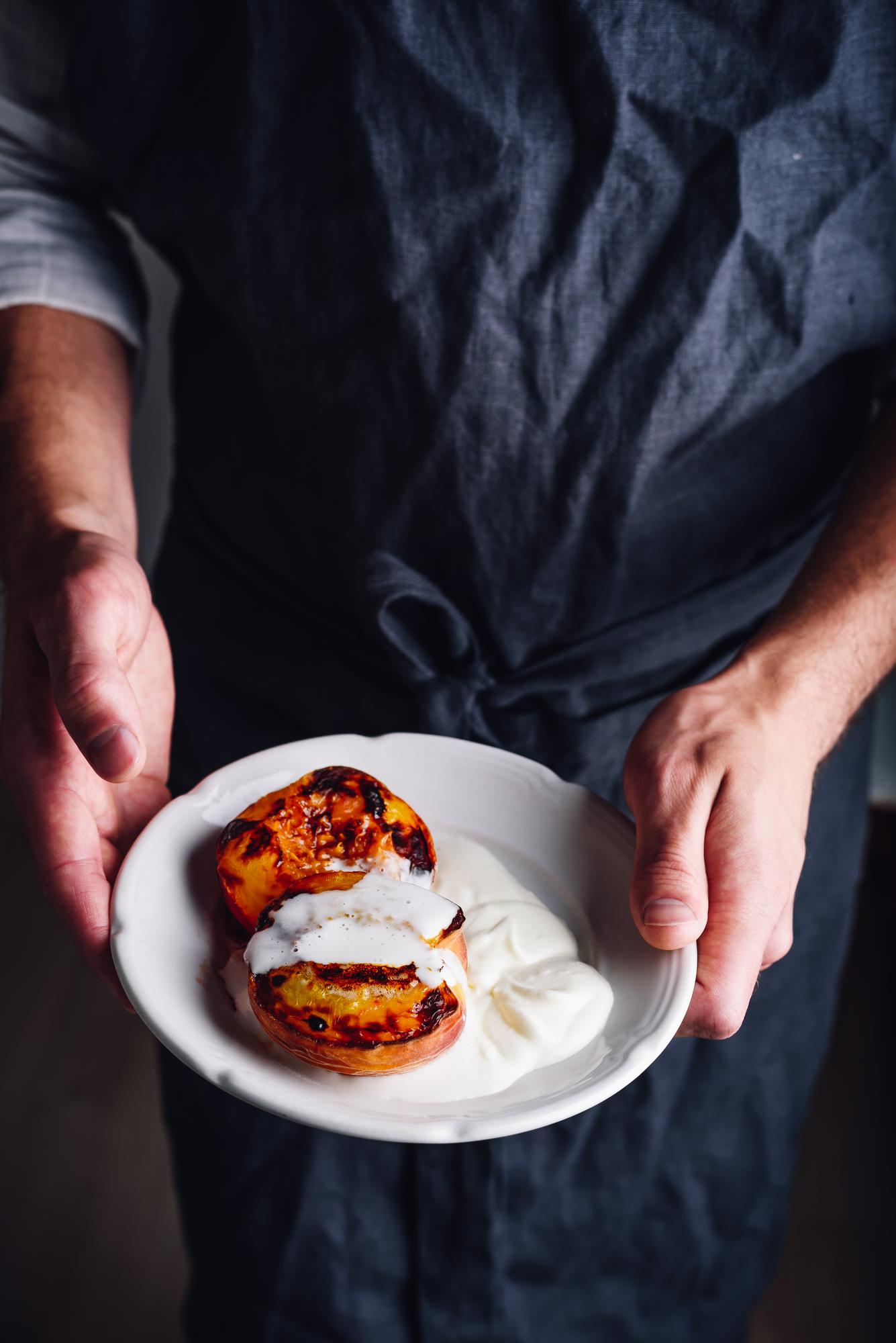 Chef arranging a composed dish on a wooden table